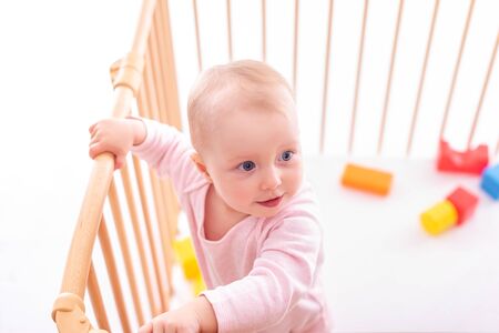 Baby girl at childrens playpen.