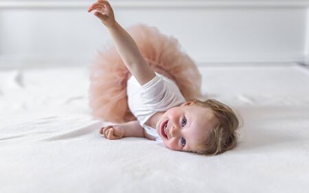 Cheerful little girl child plays in a good mood.の写真素材