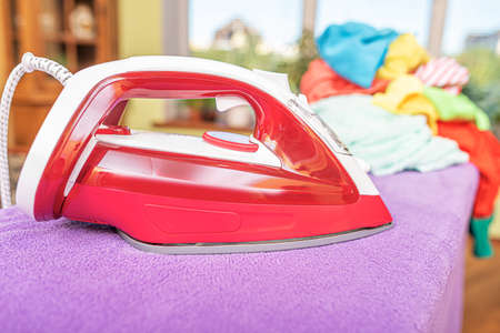 Woman ironing with iron.の写真素材