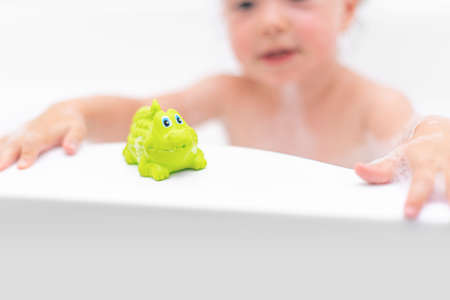 A child girl bathes in a bath.の写真素材