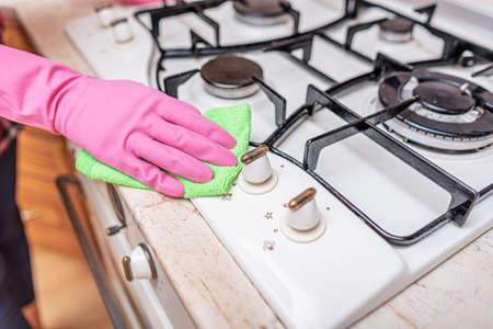 Cleaning the oven in the kitchen.の写真素材