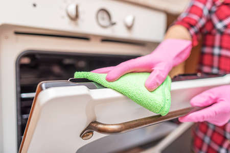 Cleaning the oven in the kitchen.