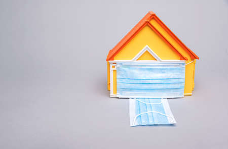 The model of the house is protected by a mask.の写真素材