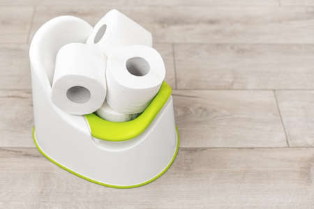 Toilet paper on a roll inside a baby potty.の写真素材