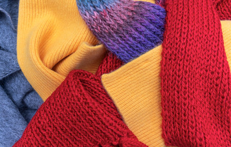 Warm knitted things lie in a pile.