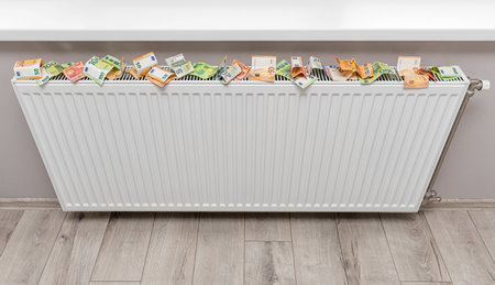 Money near the radiator. Expensive energy supply.