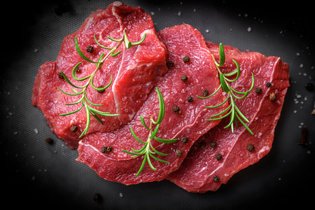 Red raw meat on a cutting board.の写真素材