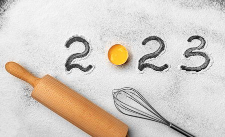 The inscription 2023 on the flour on the kitchen board.