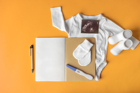 Filling out a notebook during pregnancy.の写真素材