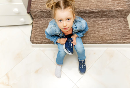 The child does not want to put on shoes.の写真素材