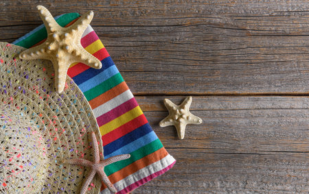 Hat and starfish on wooden boards.の写真素材