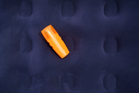 Sunscreen spray lies on an air mattress.の写真素材
