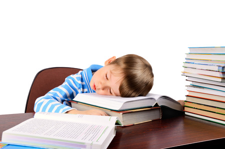 the little boy fell asleep on books. isolated on white background. horizontalの写真素材