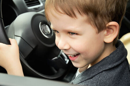 smiling boy driving horizontal closeup