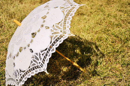 lacy parasol on the yellowed grass. horizontalの写真素材
