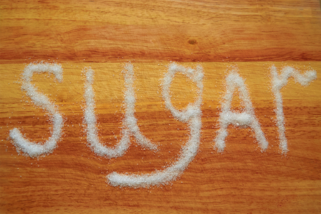 The image of sugar scattered on the Board in the form of inscriptionsの写真素材