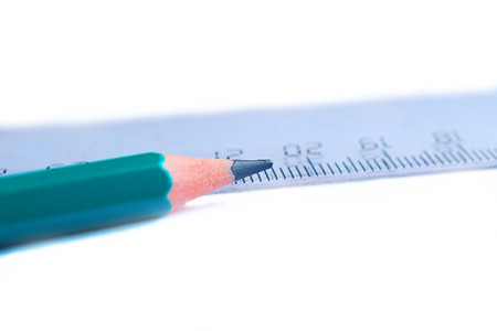 pencil and ruler lie on a sheet of paperの写真素材