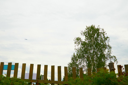passenger jet high in the sky above the villageの写真素材