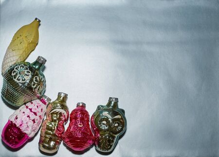 A set of old Christmas tree toys lies on a silver backgroundの写真素材