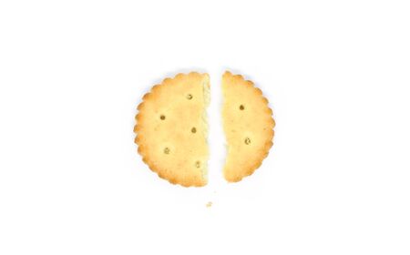 one round cracker broken into two parts isolated on a white background