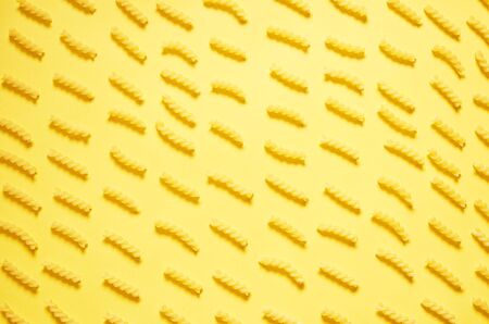 Pattern of pasta on a yellow background. The view from the top. Shadowsの写真素材