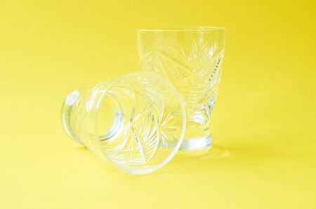 two crystal wine glasses on a yellow background close up Flatlayの写真素材