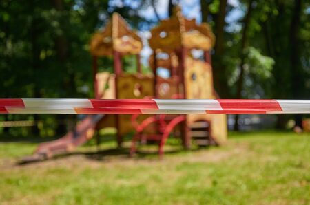 Red and white barrier tape near the Playground in the Parkの写真素材