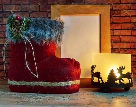 Christmas mockup with a candle holder and a Christmas Shoe. Space for textの写真素材