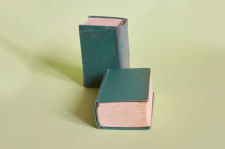 Two old books lie on a plain greenの写真素材