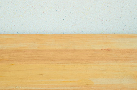 Background. A wooden table and a gray wall with black dots. Copy space