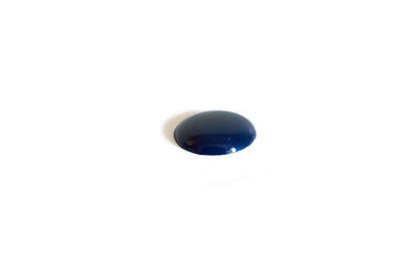 Drop of blue nail polish isolated on a white background. Vertical format.