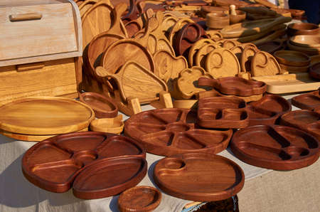 A street vendors counter with wooden plates and salad bowls.