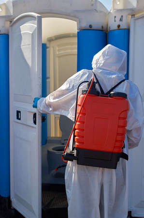 The staff of the epidemiological service disinfects toilet using a nebulizer