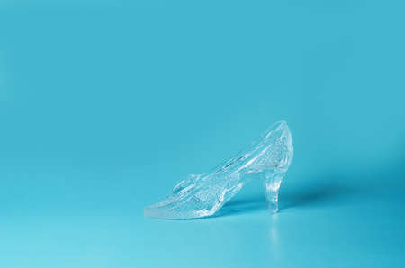 Souvenir crystal shoe on a blue background. copy spaceの写真素材