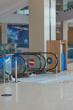 Entrance to the escalator in the shopping center. Vertical format, no people