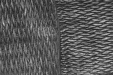 Decorative texture of a black leather product, background, close-up, vertical and horizontal stripesの写真素材
