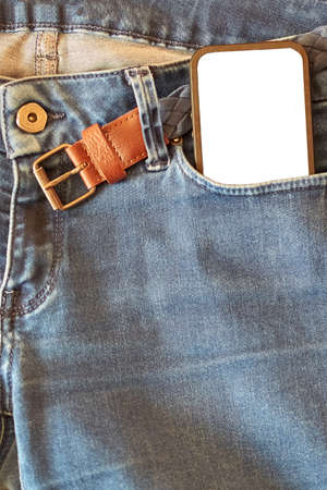 The upper part of old worn blue jeans with pockets and a white tag for clothes, front view, mockup,...