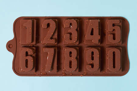 Brown silicone ice mold, numbers on a blue background, close-upの写真素材