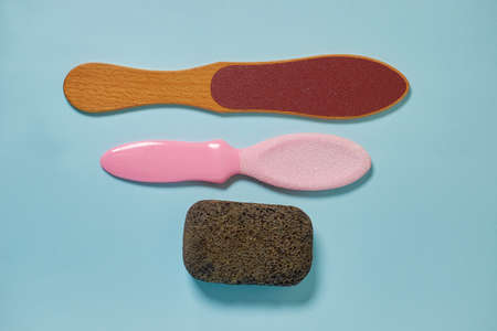 Pedicure accessories. Three types of graters for foot care on a blue background. flat lay