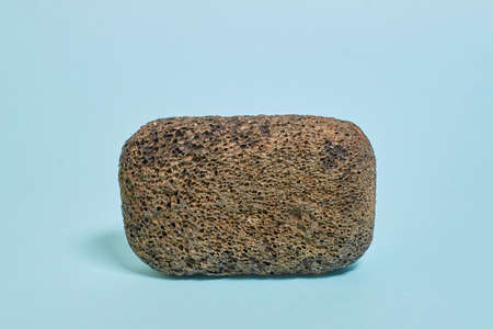 pedicure kit. Black pumice stone on a blue background. side view, close upの写真素材