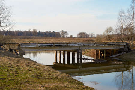 The destroyed concrete bridge over the river. Landscape, horizontal formatの写真素材