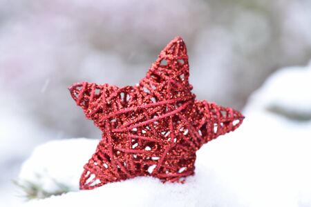 Red star on the snow. Christmas background.