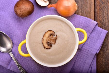 Mushroom cream soup on the wooden table. Top view.の写真素材