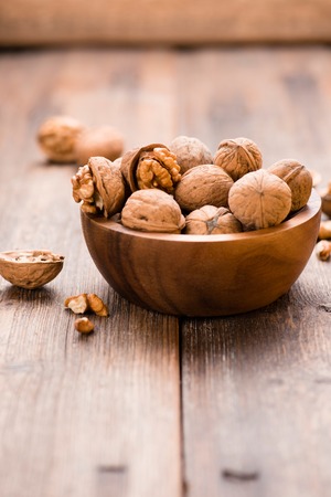 Walnuts in wooden bowl on table. Nuts.の写真素材