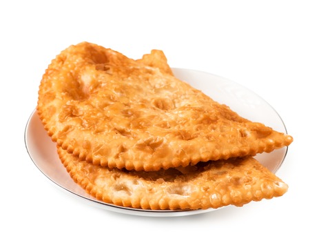 Two Chebureks on white plate isolated with clipping path. Front view. Pasties.の写真素材