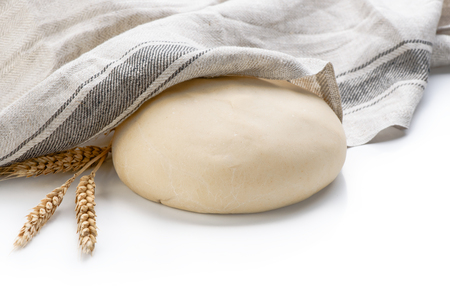 Ball of raw dough with gray napkin isolated on white background and ears wheat copy space.の写真素材