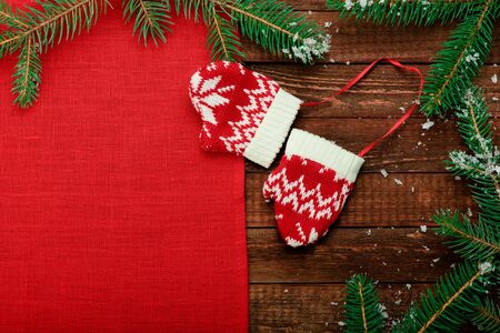 Christmas toy. Angel. Christmas holiday celebration concept. Red napkin on wooden table with Christmas tree brunch. Retro.の写真素材