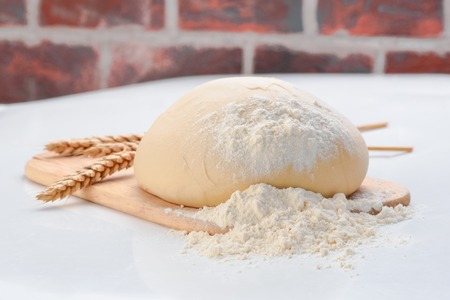 Dough with ears of wheat isolated on white backgroundの写真素材