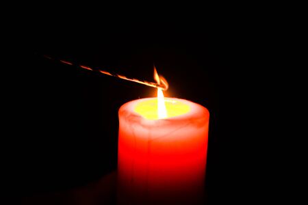 Christmas bengal fire and red candle isolated on black backgroundの写真素材