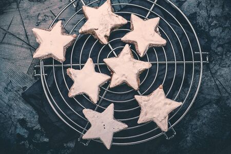Christmas cinnamon star cookies on baking wire cooling rack. Zimtsterne.